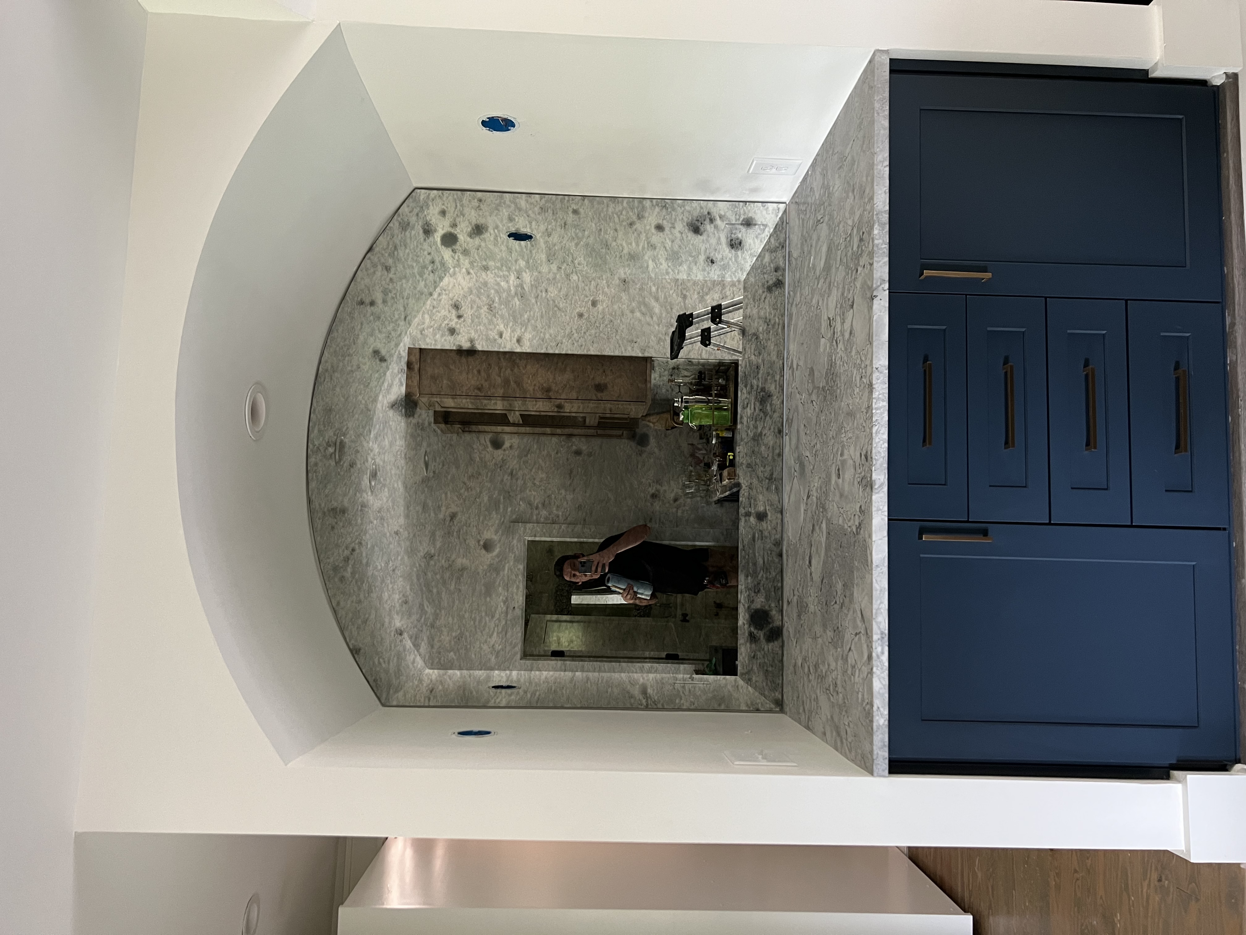 This is a Storm Antique mirror backsplash on a basement bar. The arched top makes this design pop!