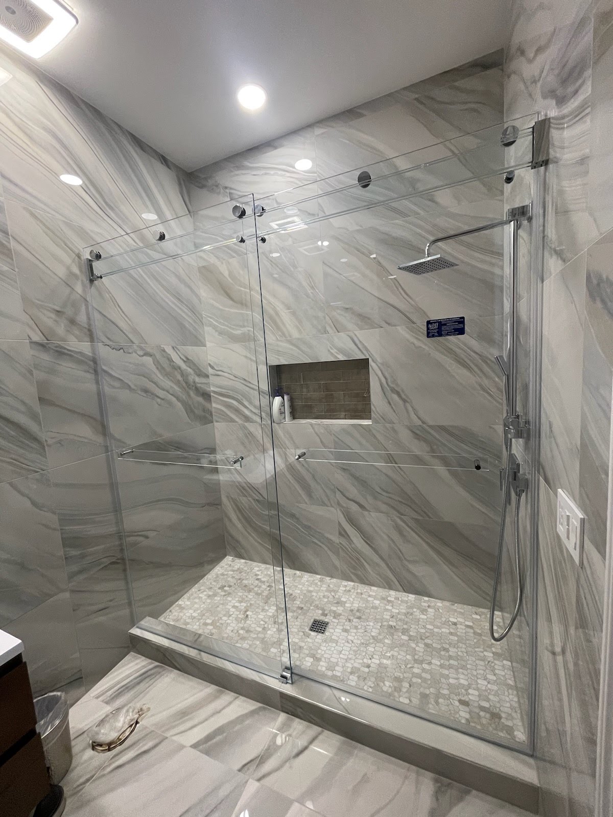 This Phantom slider has THREE hangers per door to accommodate the oversized opening width. Don't worry, the triple laminated glass bar can handle the weight! Absolutely stunning!