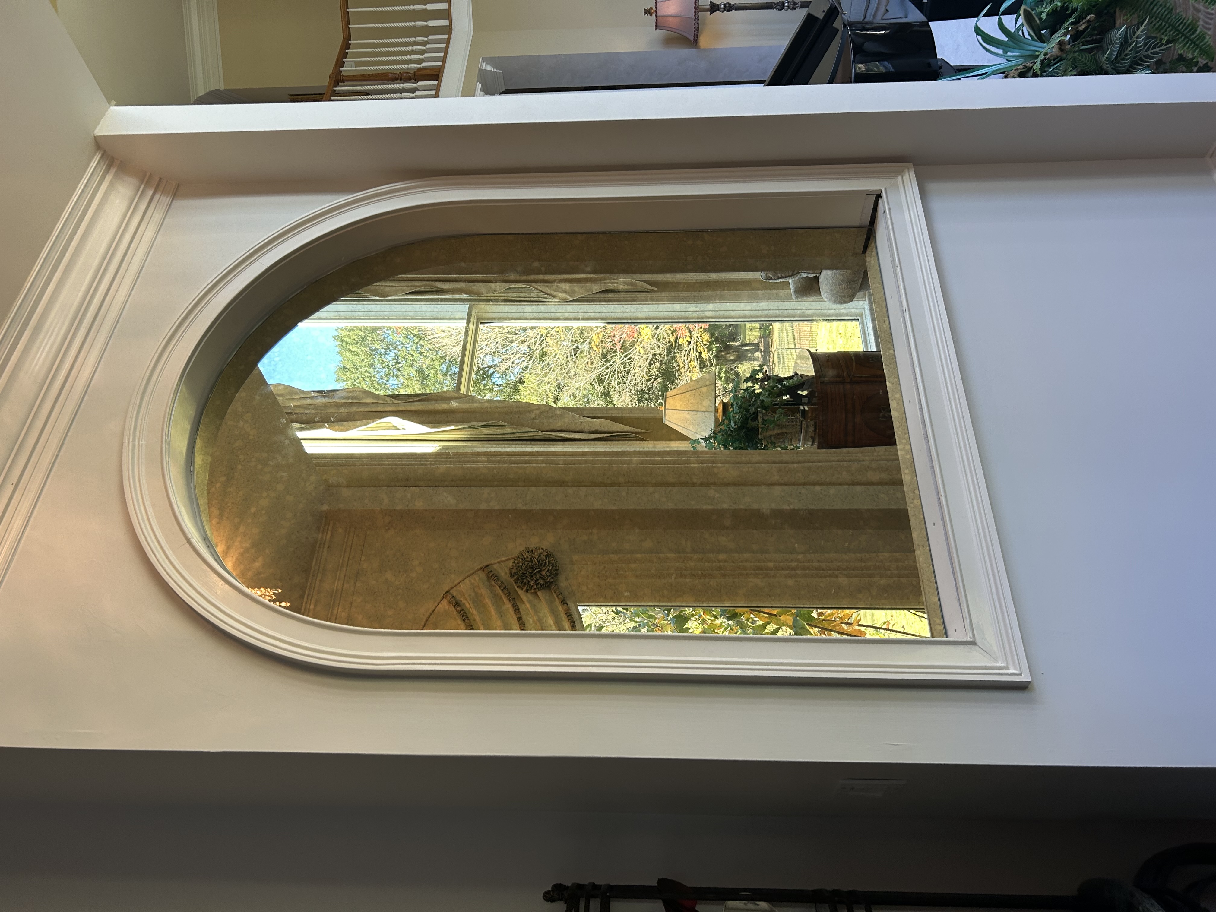 This is an exquisite 1/4" Bright Gold Antique mirror, perfectly positioned to capture the natural light and enhance the timeless elegance of the space. A true blend of beauty and decor!